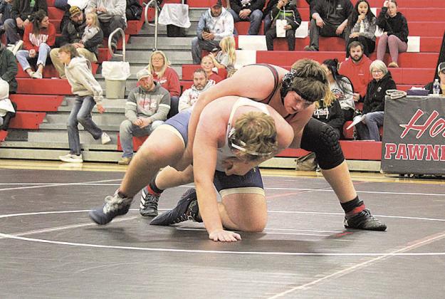 Pawnee City Indian Joel Strehle begins another round against a Lincoln Lutheran Warrior.