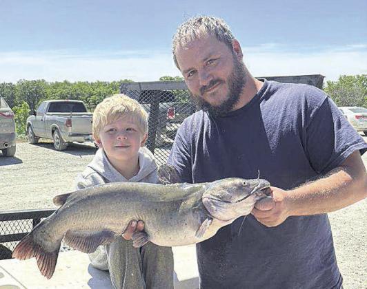 Brandon Holthus and son Leon enjoying their catch of the day during the 3rd Annual Klepper and Sons Annual Kids Fishing Derby