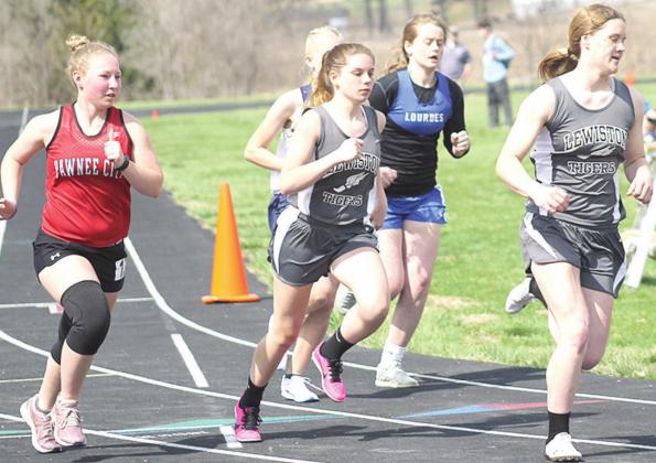 Lewiston’s Emma deKoning (right) leads the pack around the corner as teammate Masyn Arena (center) and P.C.’s Alyssa Pierce (left) follow in stride in the 3200. Paula Jasa/Republican