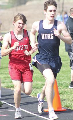HTRS’ William Taylor tries to keep one step ahead of P.C.’s Gavin McHenry in the 3200 m. run. McHenry passed him at the end to take 6th place in the event. Paula Jasa/Republican