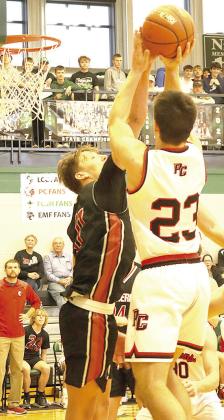 P.C.’s Anthony Kling (#23, right) pulls up on the baseline for a shot over Wymore-Southern. Paula Jasa/Republican
