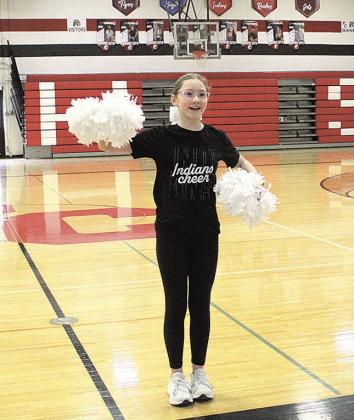 Cheerleader Ella Wernimont leads her schoolmates in cheers at the Pawnee City wrestling pep rally
