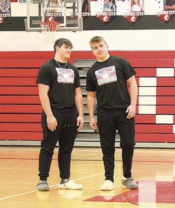 Dylan Layne (left) and Gauge Schuetz (right) receive applause from their school during a pep rally
