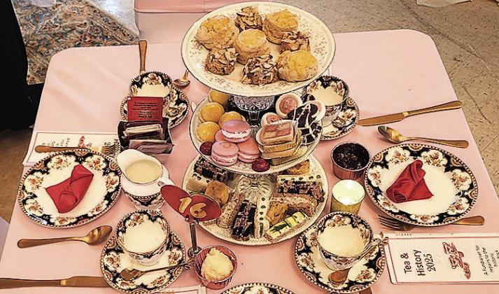 Each table was table was set with a different sent of china and silverware on pink tablecloths. There were three tiers finger foods either savory or sweet.