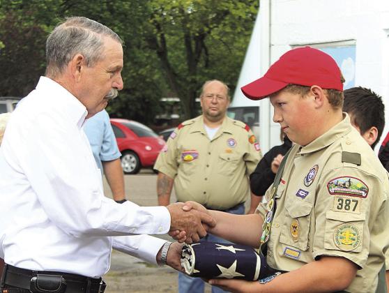 Photos 1 &amp;amp; 2: In a 2017 ceremony, Lee Malmos entrusts the burial flag of his uncle Clarence Morton to Boy Scout Andrew Stalder. Scout leader Brian Jones is in the background. Troop 387 raised Clarence’s flag to be flown on Memorial Day weekend. Photo 3: As part of the special remembrance ceremony, Clarence Morton’s burial flag is flown on Memorial Day weekend in 2017, for the first, and probably last, time.