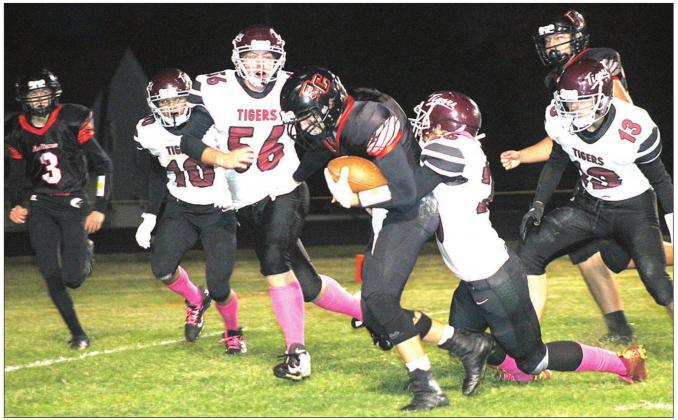 Pawnee City’s Kyle Gyhra (center) takes off on a run as Lewiston’s Brady Bledsaw (#13, right), Tristen Ray (tackling), Ty Arena (#56) and Gabe Garcia (#10, left) try to chase him down. Also pictured is P.C.’s Kylenn Koester (#3, left) running to help out. Paula Jasa/Republican
