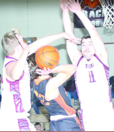 LHS’ Everett Bohling (left) makes a big block against a Diller/Odell player as teammate Brady Bledsaw (#11, right) goes up to do the same. Paula Jasa/Republican