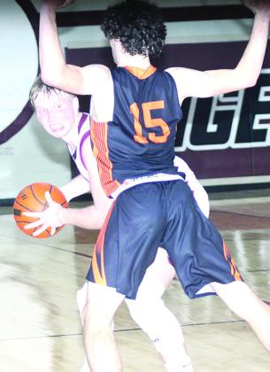LHS’ Caleb Rule (left) peeks into the corner against a Diller/Odell player in Friday night’s game. Paula Jasa/Republican