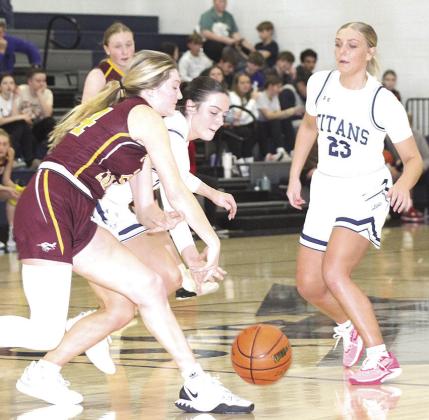 HTRS’ Lillian Bowen (center) goes for a loose ball against Sterling as teammate Jaylie McNealy (#23, right) looks to help out. The Lady Titan defeated the Lady Jets on Friday night by a 48-38 score. Paula Jasa/Republican