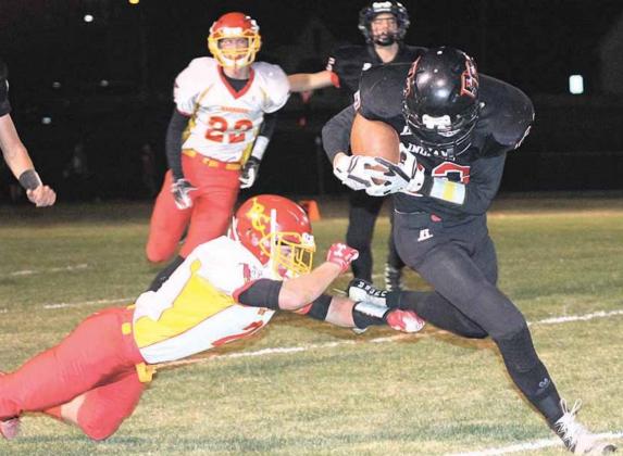 P.C.’S Kyle Gyhra (#22, right) keeps a handle on the ball while busting through tackles on this 45 yard touchdown run in the 2nd quarter. Paula Jasa/Republican