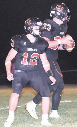 P.C.’s Andy Maloley (#12) protects QB Simon Osborne ((#33, right) in the backfield against Red Cloud. Paula Jasa/Republican