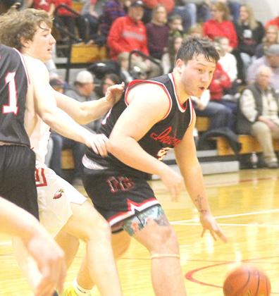 P.C.’s Joey Marteney (right) drives past a J-B defender in the D1-1 subdistrict final. Marteney scored 10 points and had 5 rebounds, 2 steals and 1 block in the game. Paula Jasa/Republican