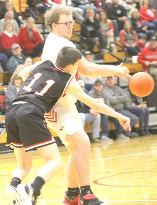 P.C.’s Brysen Horst (#11, left) picks off an errant J-B pass in the final minutes of the game. Horst had 5 rebounds, 1 steal, 1 block and 1 point against J-B. Paula Jasa/Republican