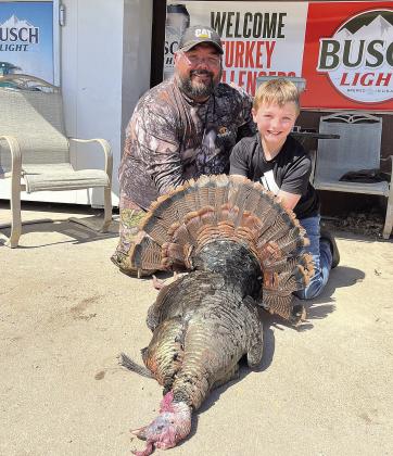Mason Ellston (right) and his dad, Cole (left) pose with Mason’s turkey
