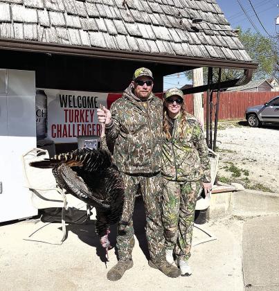 Michael Carpenter (left) poses with his wife and his