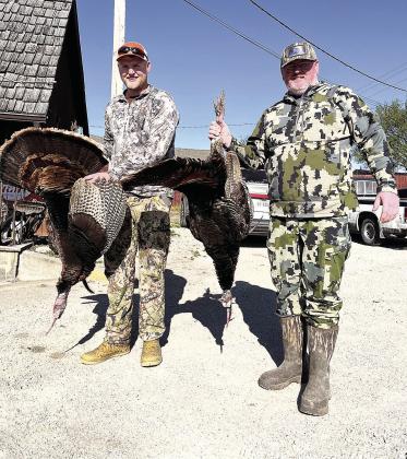 Bo Henry (left) and his dad Casey (right) hold their birds
