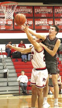 P.C.’s Anthony Kling (#23, left) and LHS’ Ashton Sanders (#23, right) battle for a rebound under the basket, but Sanders draws the foul on the play. Paula Jasa/Republican