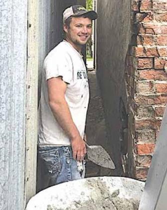 Brick mason Brandon Schawang doing some critical repair at the back of the building. Sharla Sitzman Photo