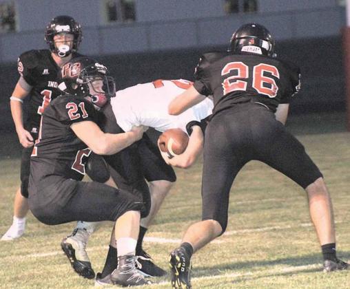 P.C.’s Kyle Gyhra (#22, above) makes a PAT catch while teammates Clayton Shook (#21) and Bryce Gyhra (#26 pictured right) make a stop on a Meridian player. Pawnee City won their first game in almost three years against Meridian by a 39-16 score. photos by Paula Jasa/Republican