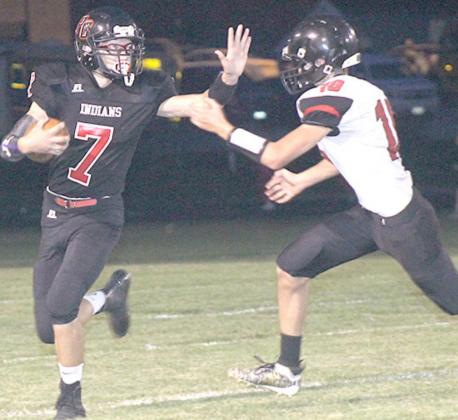 P.C.’s Jacob Lytle (#7, left) stiff arms a would-be Meridian tackler on a big run on Friday night. Paula Jasa/Republican