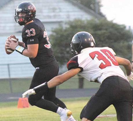 P.C.’s Simon Osborne (#33, left) eludes a Mustang player in the backfield. Paula Jasa/Republican