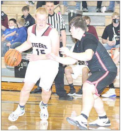 LHS’ Jonathan Janssen (#15, left) drives towards the paint against a Cedar Bluff defender on Friday night. Janssen led the team with 4 assists and 2 blocks. Paula Jasa/Republican