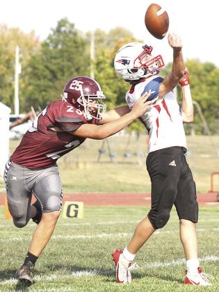 LHS’ Brock Janssen (#25, left) almost forces the Parkview Christian QB to throw an interception before halftime on Friday. Lewiston won the game 40-14. Paula Jasa/Republican