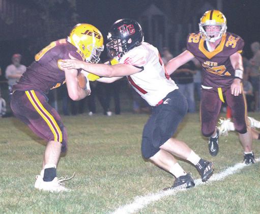 Pawnee City’s Clayton Shook (#21, center) stops a Sterling ball-carrier for a loss behind the line in Friday night’s game. Paula Jasa/Republican