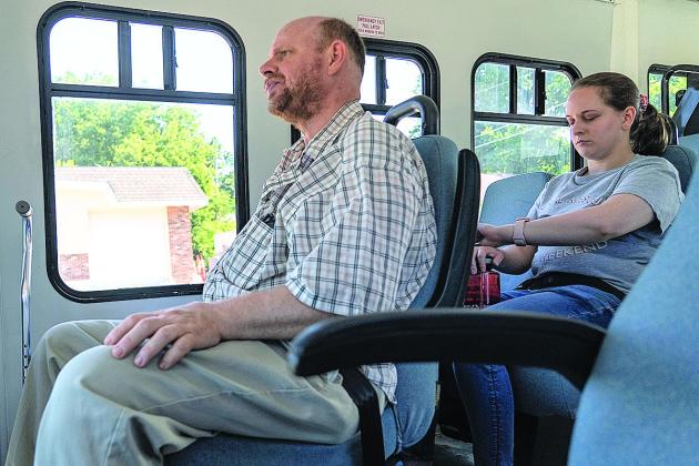 Olivia Wheeler (right) checks her watch as the Lancaster County Public Rural Transit bus brings her from her home in Waverly to her job in south Lincoln on June 17. Photo by Lily Smith/Flatwater Free Press