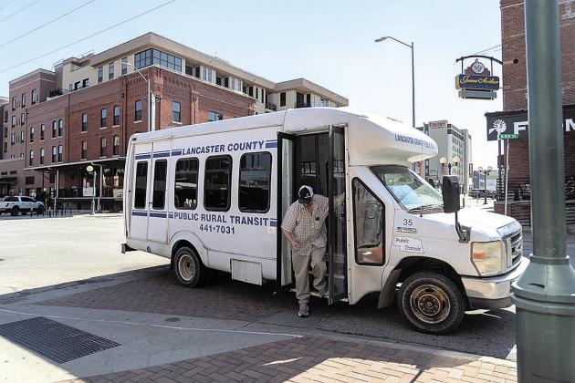 Joseph Peterson descends the stairs from the Lancaster County Public Rural Transit bus in Lincoln’s Haymarket District after receiving a ride from his home in Ceresco on June 17. Photo by Lily Smith/Flatwater Free Press
