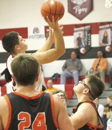 Paula Jasa/Republican P.C.’s Anthony Kling (left) soars through the lane past two Diller/Odell defenders. Kling amassed 30 points against the visiting Griffins in the Indians’ 57-40 victory.