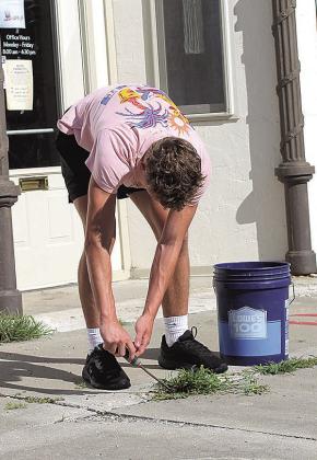 High school students Jace and Payton help City Councilwoman Susan Eisenhouer tidy Pawnee City sidewalks. "Every thing they do is one less thing the city crew has to do," Eisenhouer said.