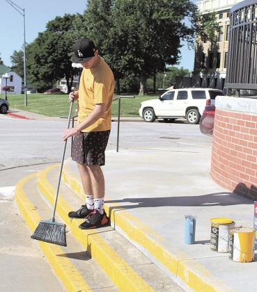 High school students Jace and Payton help City Councilwoman Susan Eisenhouer tidy Pawnee City sidewalks. 'Every thing they do is one less thing the city crew has to do,' Eisenhouer said.
