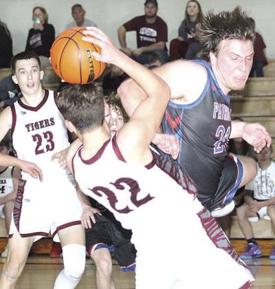 LHS’ Brock Janssen (#22) gets fouled during a rebound while teammate Ashton Sanders (#23) looks on. Paula Jasa/Republican