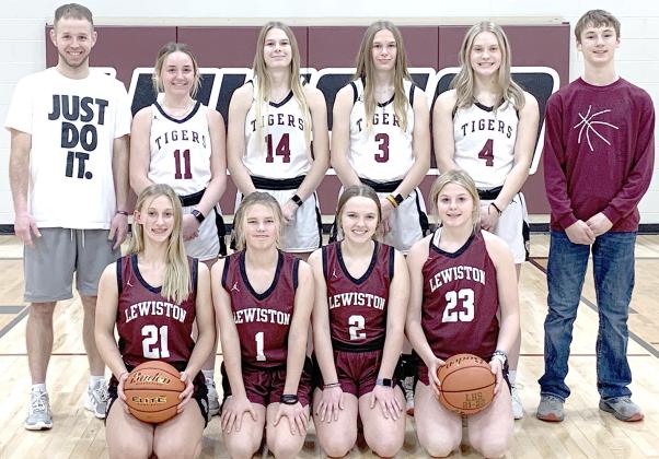 Members of the 2022-23 Lewiston Girls’ Basketball Team are front, from left: Maddie Janssen, Ayden Hunzeker, Jenna Anderson, DeLayne Currie. Back row, from left: Head Coach Kyle Asche, Carleigh Weyers, Meagan Sanders, Katelyn Sanders, Emma de Koning, Payton Heideman, s.m. Not pictured: Asst. Coach Alex Callan, Leah Christen, Justice Currie, s.m.