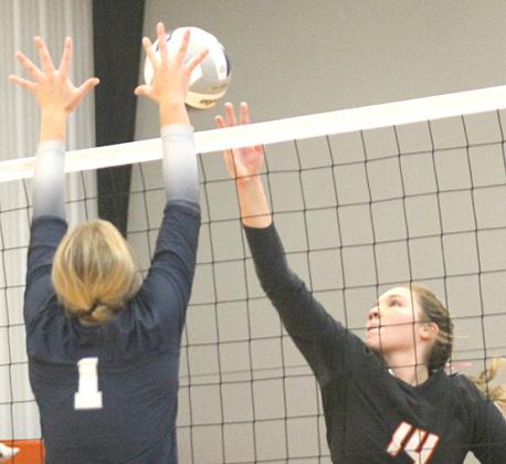Paula Jasa/Republican HTRS’ Laramie Glathar (#1, left) gets her hands on an ace block against Diller/Odell’s best hitter, Karli Heidemann