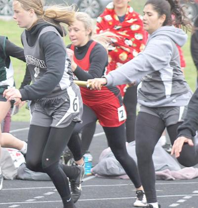 LHS’ Katelyn Sanders (left) takes the handoff from teammate Nayla Alos in the 400 M. relay event. Paula Jasa/Republican