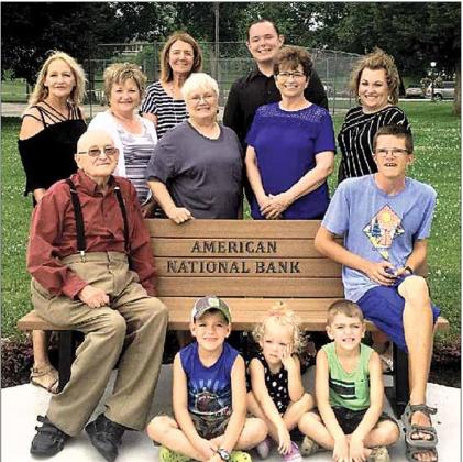 Shown in back row left to right is Jan Wilhelm Lions Club Trail Designer / Grant Writer, Rhonda Joy Bank Employee, Deb Lewis Bank President, Bev Simon lions Club Trail Secretary/ Treasure, James Jones Bank Employee, Nancy Crook Bank Employee, Megan Herr Bank Employee. Sitting on Bench is Ron Rist Lions Club President, Head of Trail and Lance Lewis. Sitting on the sidewalk in front is Megan Herrs’ children, Sutton, Corbin, and Jackson.