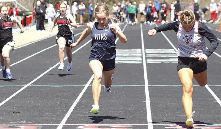 Lewiston’s Justice Currie (right) crosses the finish line just ahead of HTRS’ Miranda Rist (center) in the girls’ 100 M. Dash prelims. Also pictured (from left) are Pawnee City’s Ericca Gyhra and Dakota Dean. Paula Jasa/Republican
