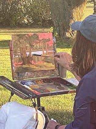 Debra Joy Groesser demonstrates how to paint at the Paint Out event in Auburn last week. She is President of a the American Impressionist Society and a well-known professional artist.