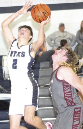 HTRS’ Brennen Vaughan (#2, left) goes up for a bucket down low as LHS’ Tristen Ray (#24, right) looks on. Paula Jasa/Republican