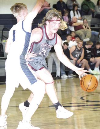 LHS’ Tristen Ray (#24, right) drives the ball at the top of the key as HTRS’ Brogan Dunlap (#1, left) defends. Paula Jasa/Republican