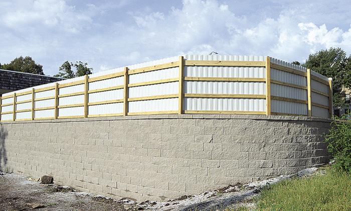 A view of the back of the fence and retaining wall Photo by Joe Norman