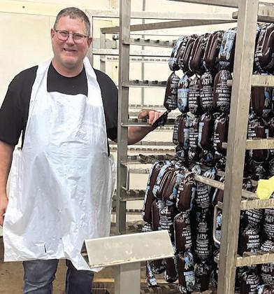 Den Schaardt with 400 pound cart of deer sausage headed for smoker.
