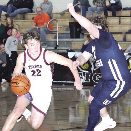 LHS’ Brock Janssen (#22, left) drives the lane past an OCA defender in the Tigers’ 66-45 victory on Saturday. Janssen scored 10 points in the game. Paula Jasa/Republican