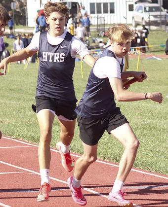 HTRS’ Axton Wamsley takes the handoff from teammate Kameon Dettmann in the boys’ 1600 M. relay. Paula Jasa/Republican