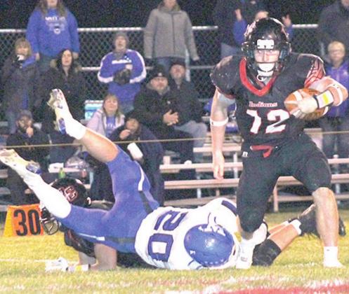 Pawnee City’s Andy Maloley (#12, right) hurdles a would be tackler to gain more yards. Maloley led the Indians with 27 carries for 164 yards against Wallace. Paula Jasa/Republican