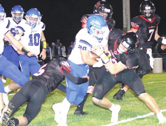 Pawnee City’s Justin Pierce (#5, left) and Andy Maloley (right) stop a Wallace ballcarrier in his tracks in Friday night’s State quarterfinal playoff game. Paula Jasa/Republican