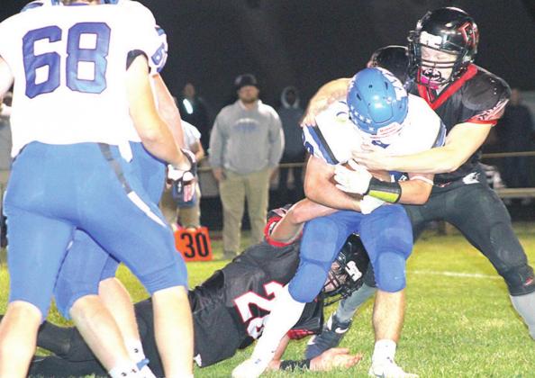 Pawnee City’s Bryce Gyhra (#26, below left) and Clayton Shook (#21, right) team up on a tackle against Wallace on Friday night. They each had 1/2 a sack. Paula Jasa/Republican