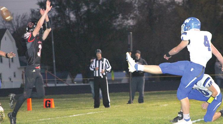 Pawnee City’s Kylenn Koester (#3, left) tries to block Wallace’s PAT kick attempt on Friday night. Paula Jasa/Republican